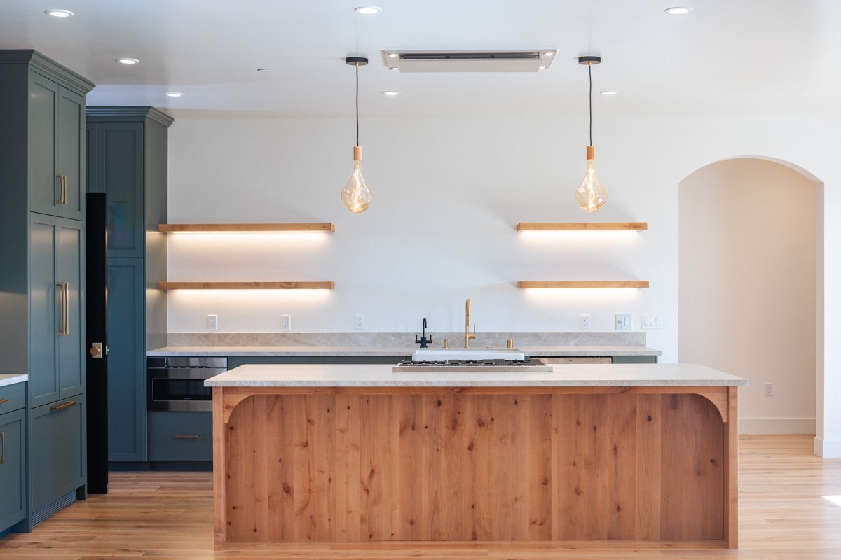 Alan Drive new construction — blue cabinet kitchen with floating shelves